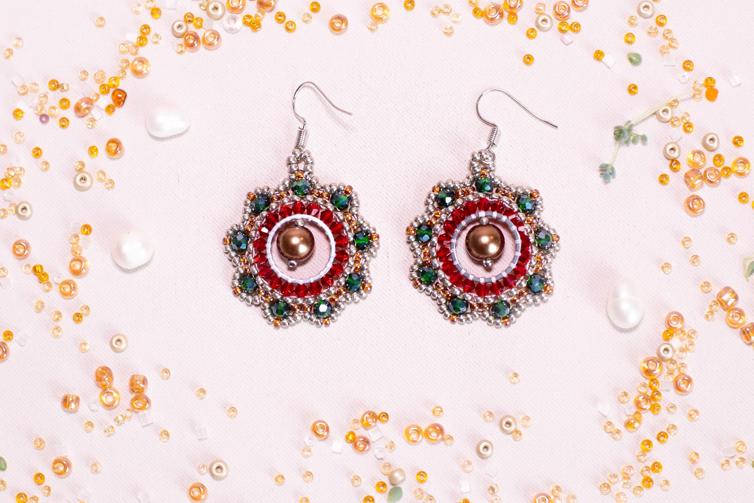 a pair of red and green beaded earrings